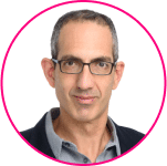 A man with short dark hair, wearing glasses, a gray collared shirt, and a dark jacket, is pictured against a white background with a pink circular border—perfect for discussing SSO myths or Single Sign-On best practices.