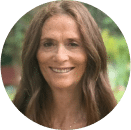 A woman with long brown hair smiles at the camera, standing outdoors with greenery in the blurred background, reflecting confidence in cybersecurity and awareness of financial crime.