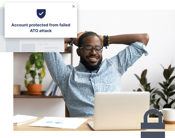 A man sits relaxed at a desk with a laptop, while a popup message reads, "Account protected from failed ATO attack—stop more ATOs effortlessly.
